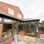 A conservatory in a home with a table and chairs available for use as a Conservatory Extensions in Bishop's Cleeve.